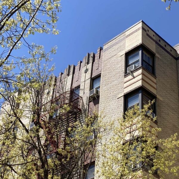 art deco apartment building corner with trees